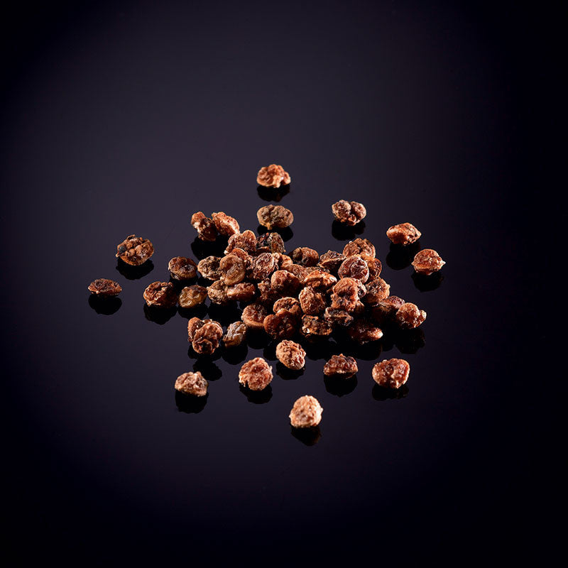 Getrocknete und geschälte rosa Beeren