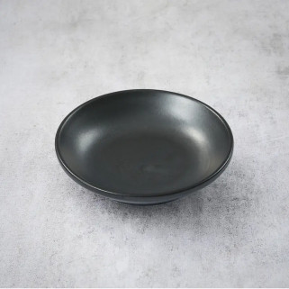 Black cup with soy sauce or tsukemono